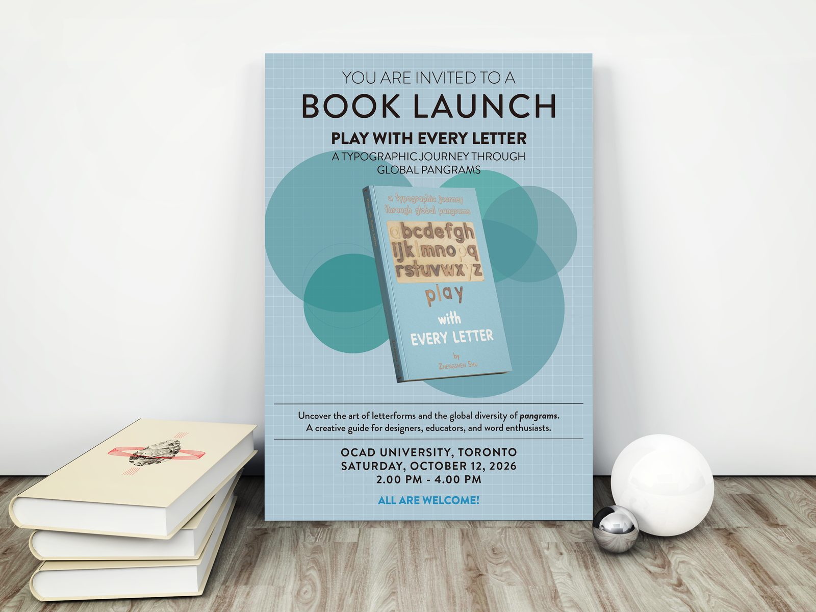 The launch poster leaning against a wall beside a stack of books