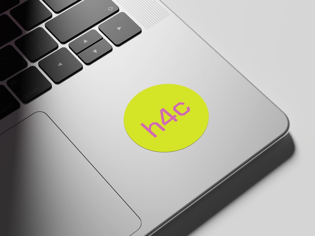Laptop sticker mockup: h4c in pink on a lime circle