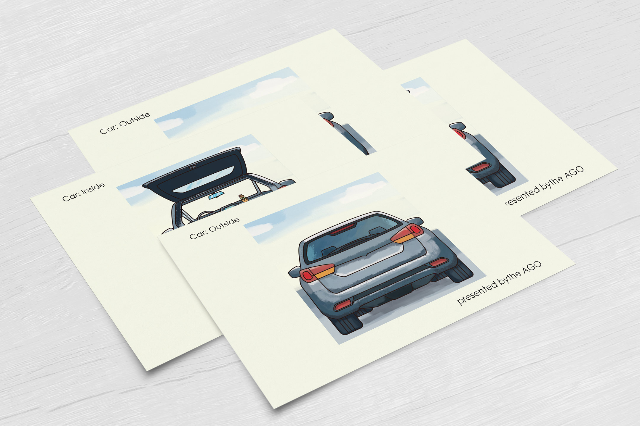 All four postcards fanned out on a pale wooden table