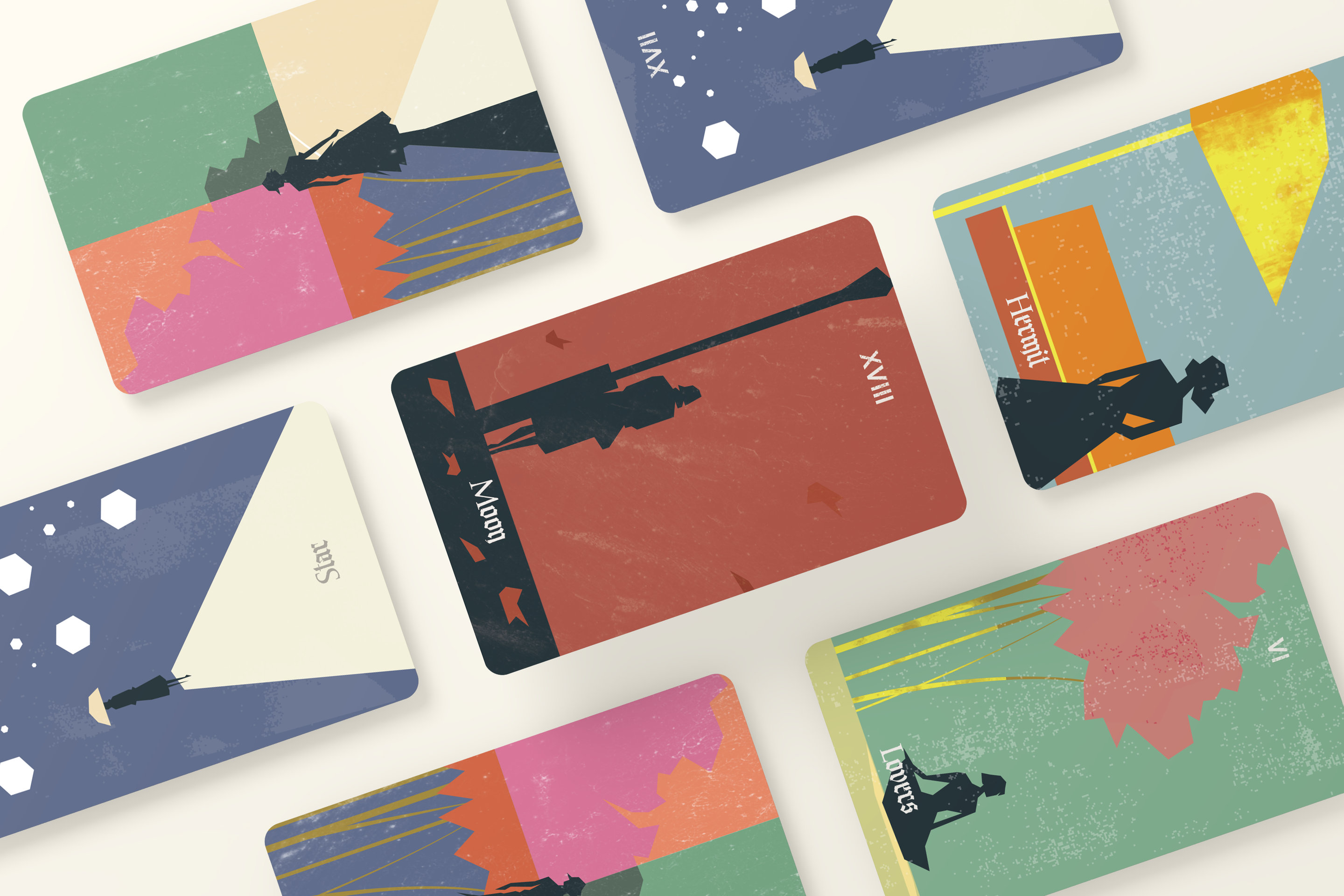Tarot cards spread on a table, each with a silhouetted figure