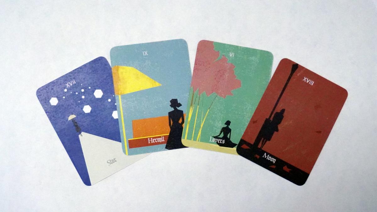 Four printed cards with rounded corners fanned out: the Star, the Hermit, the Lovers and the Moon