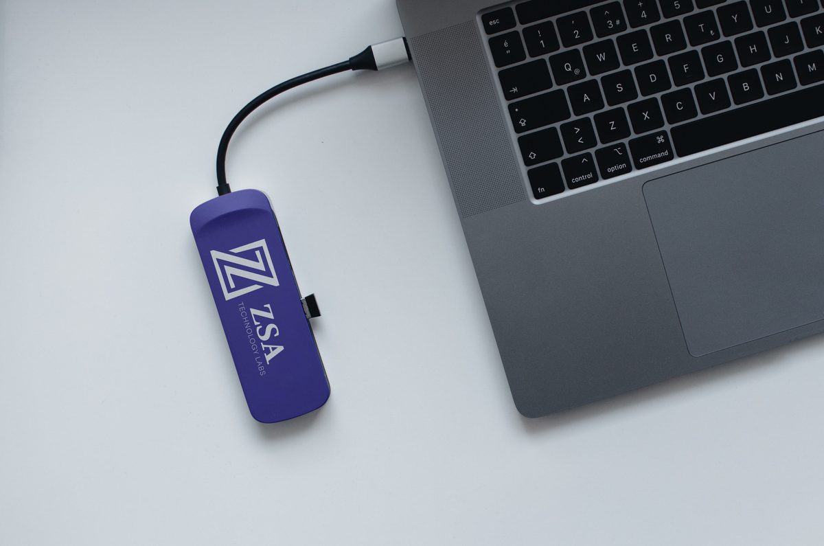 Purple USB-C adapter with the Z mark, plugged into a laptop