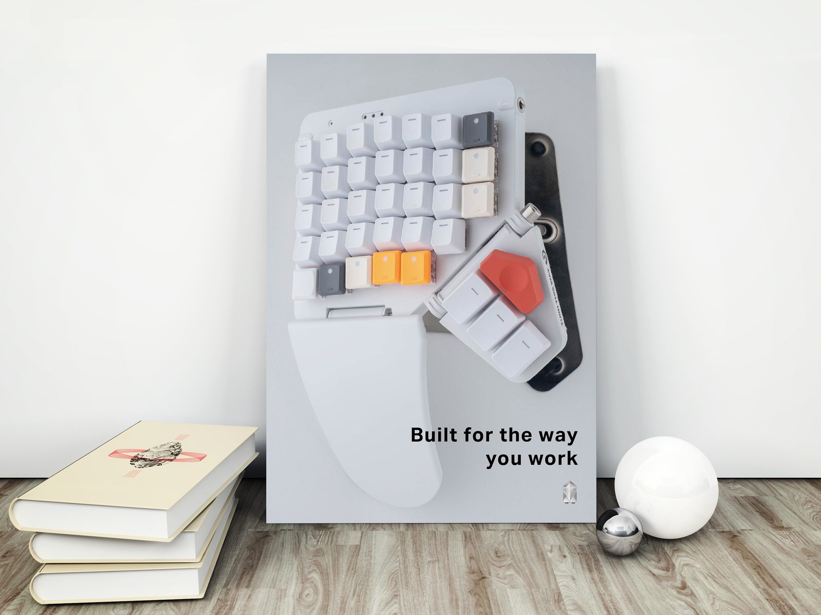 The Built for the way you work poster leaning against a wall beside books