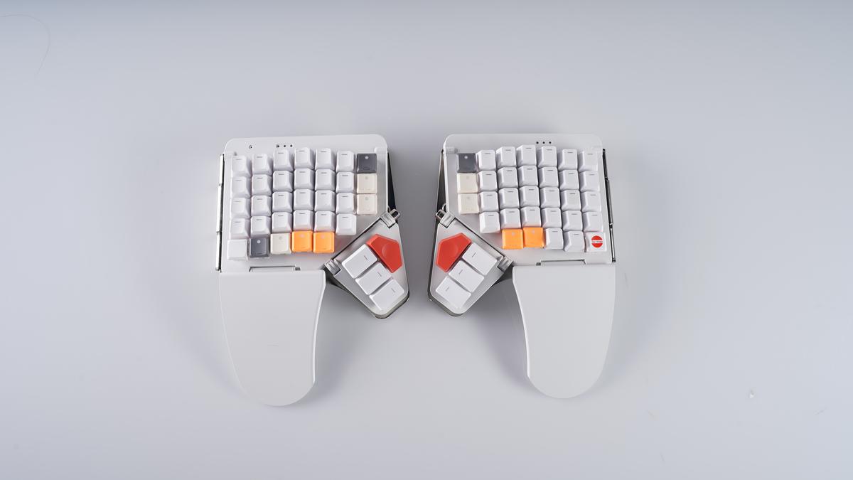 Unedited product photo of the two keyboard halves from above, on grey